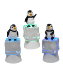 Penguin Sitting on Color-changing Lighted Icecube -